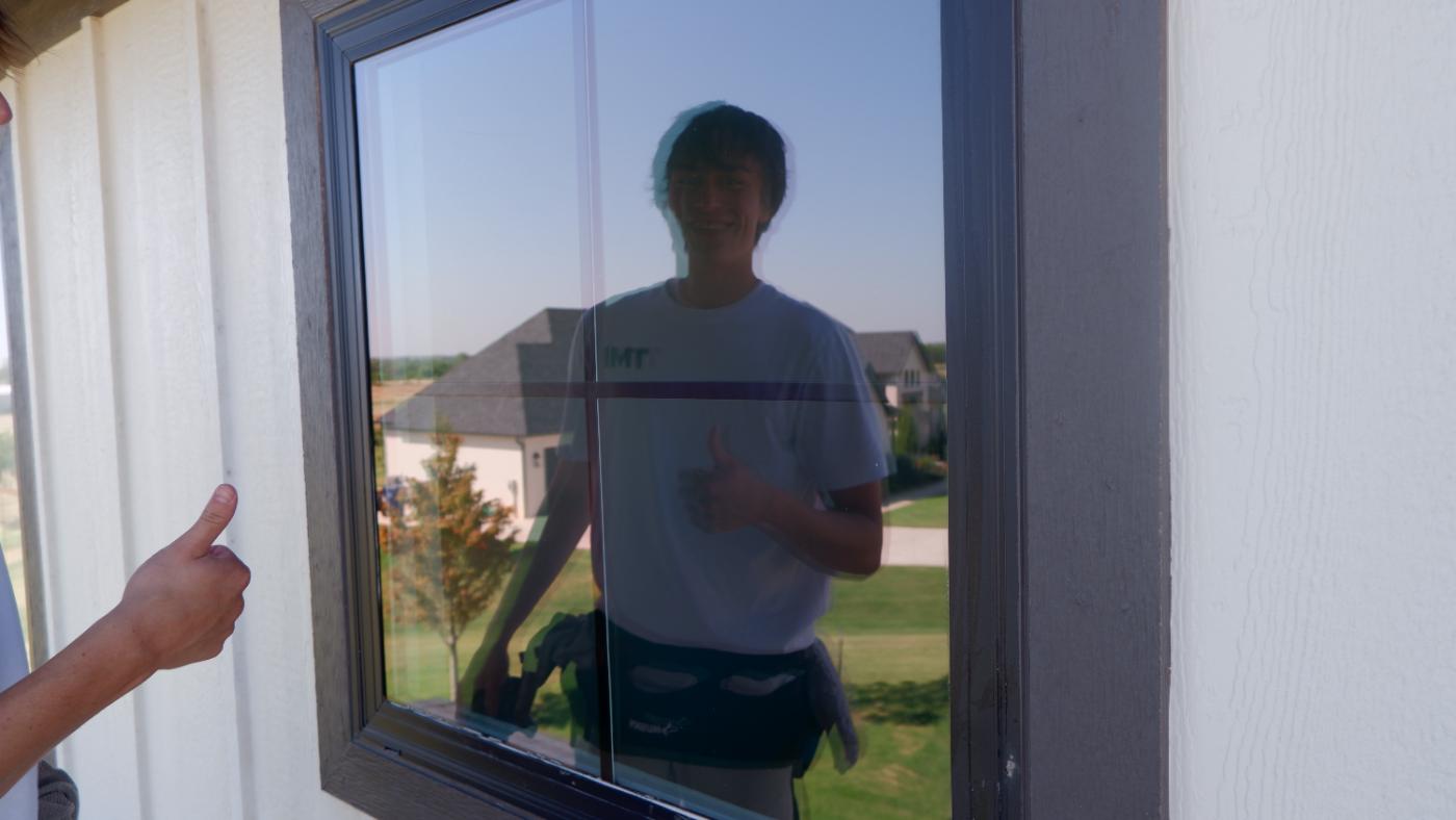 TMI crew member carrying cleaned glass panels