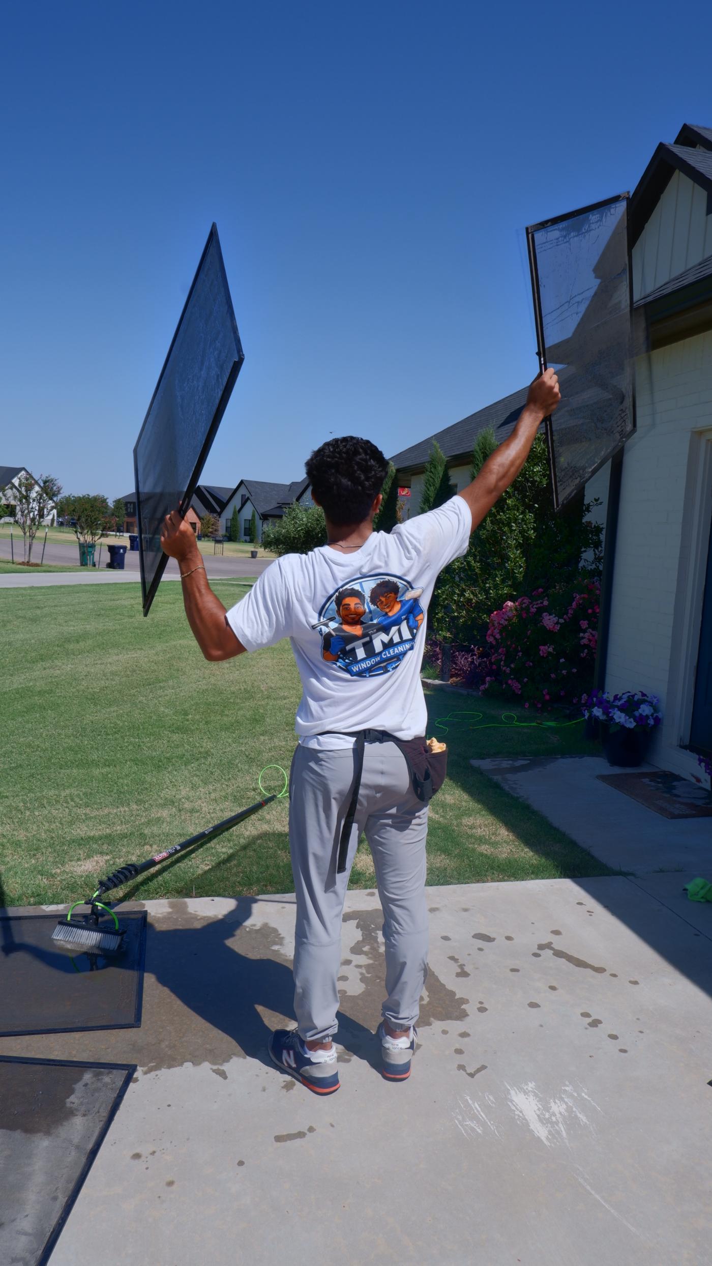 TMI crew member holding freshly cleaned window screens