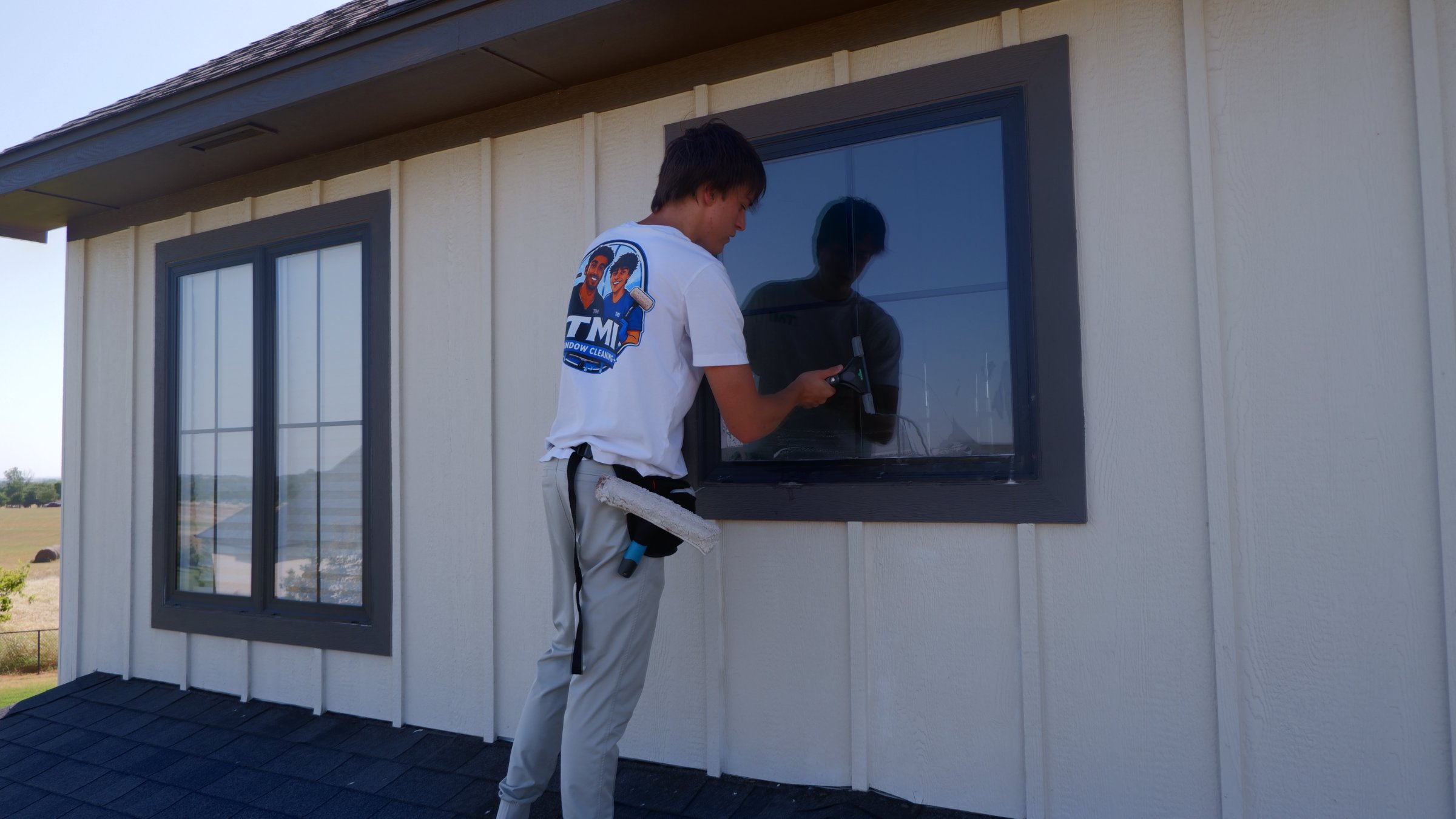 TMI crew member cleaning a window